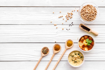 Cook chickpeas. Make hummus. Bowls with grains and ready meal near spices on white wooden background top view copy space