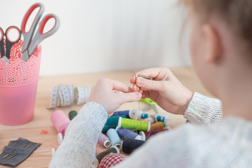 girl sews doll clothes, Child sewing 