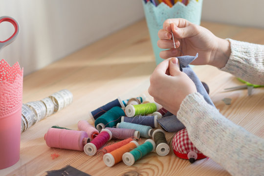 girl sews doll clothes, Child sewing 
