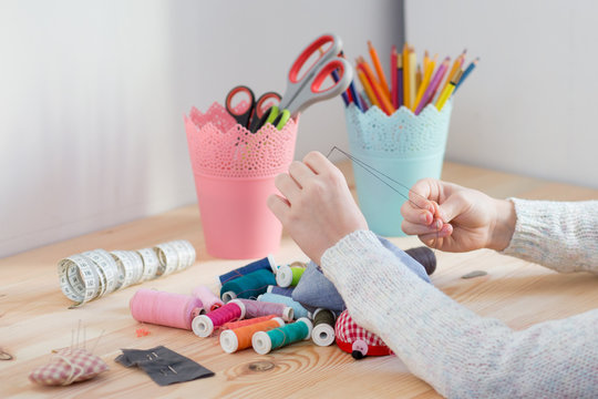 girl sews doll clothes, Child sewing 