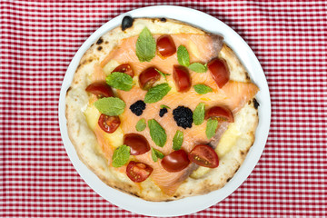 tasty salmon pizza on a the table
