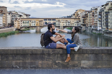 Couple at sunset in front of Ponte Vecchio, Florence