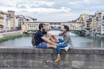 Couple at sunset in front of Ponte Vecchio, Florence