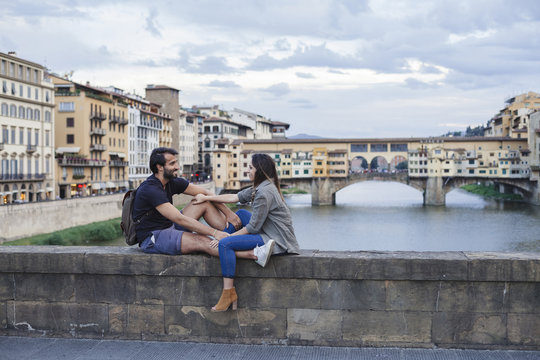 Couple at sunset in front of Ponte Vecchio, Florence