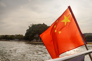 The flag of China fluttering on boat in Guilin
