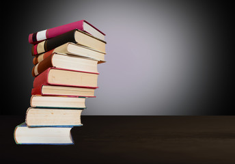 A lot of books stacked on top of each other