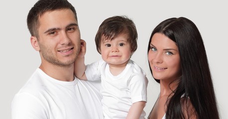 Fototapeta premium Happy family with newborn baby on a white background.