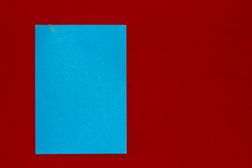 Blue paper on red frieze fabric
