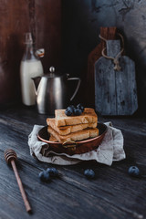 close up view of toasts with blueberries on plate on wooden tabletop