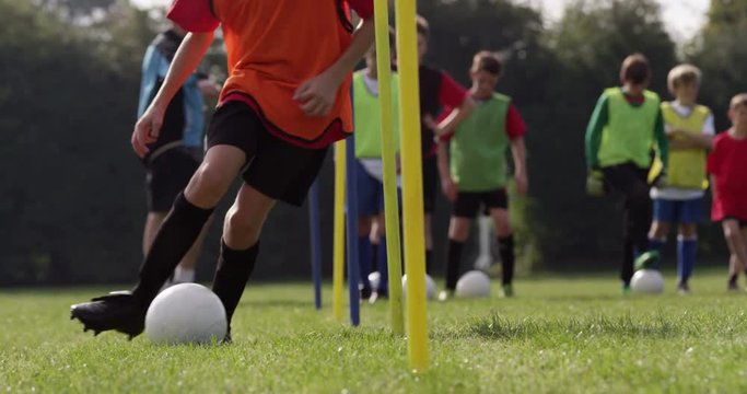 Group of boys training before their soccer match.Shot in slow motion on RED Epic
