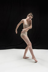 Young teen dancer on white floor background.