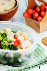 Steaming fresh vegetables in the kitchen, preparing a healthy meal with broccoli, cauliflower and carrots