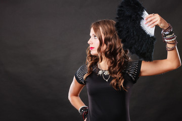 beautiful brunette woman with black fan in hand