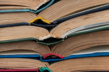 Stack of the old open books for background