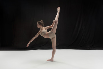 Fototapeta premium Young teen dancer on white floor background.