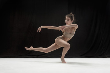 Fototapeta na wymiar Young teen dancer on white floor background.