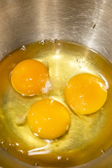 Three eggs in an iron bowl