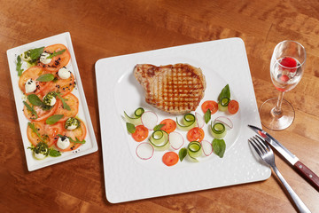 Grilled meat fillet steak with vegetables and caprese salad