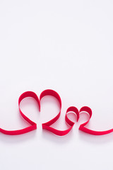 two red hearts from ribbon on white, valentines day concept