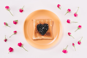 top view of toast with jam on yellow plate isolated on white