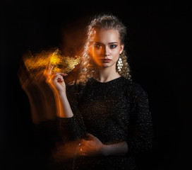 Naklejka premium Luxury young woman with a gold mask. Effect of mixed light.