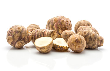 Jerusalem artichoke tubers set with two sliced halves isolated on white background sweet crisp topinambur.