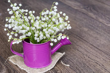 Lily of the valley bouquet on a  wooden background