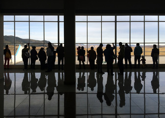 Silhouettes of travellers in departure hall