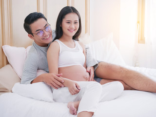 Happy pregnant woman and her husband waiting for baby, happy family love and care.