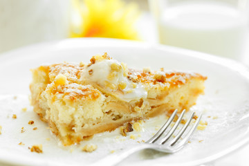A piece of Apple Pie with ice-cream and nuts on a white background