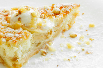 A piece of Apple Pie with ice-cream and nuts on a white background