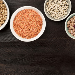 Legumes on dark background, from above with copy space