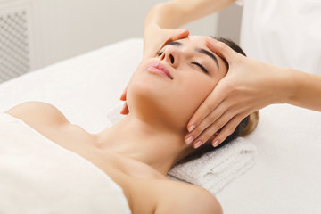 Fototapeta na wymiar Woman getting professional facial massage at spa salon