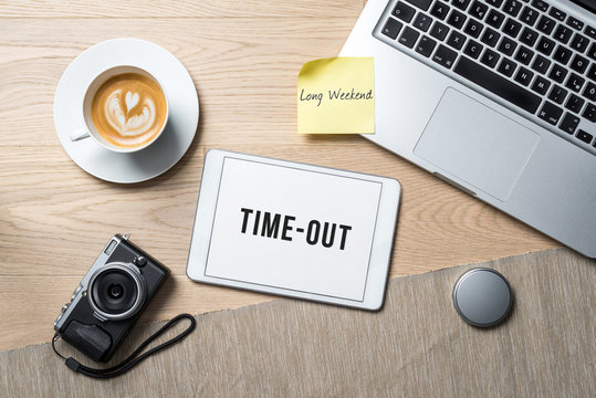 Time-out written on tablet in office as flatlay