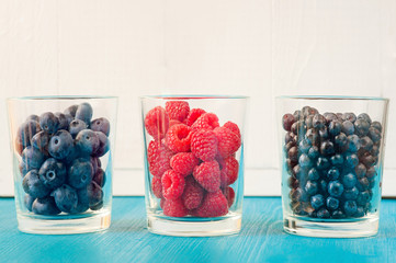 three glasses of summer berries - raspberries, blueberries