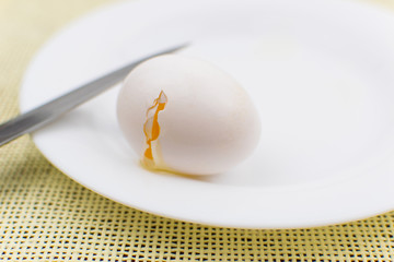 Broken eggs with a knife.