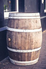 Fototapeta premium Empty beer barrel in street outside, closeup. Toned