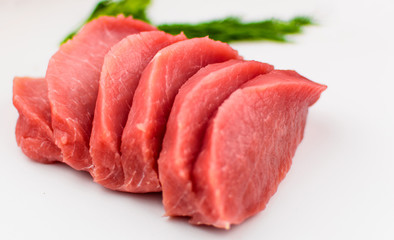 Pork fillet chopped on a white background.