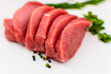 Pork fillet chopped on a white background.