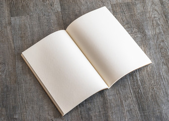 Blank open A4 size book, catalog, magazine, brochure, or booklet mock up template paper texture on brown wood table floor