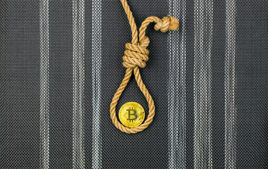 End of bitcoin. Coin bitcoin in the loop of the gallows.