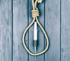 Drugs are suicide. A syringe in a loop for the gallows.