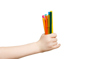 Children's hand holding colorful markers. isolated