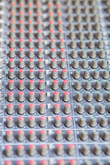 audio mixing console knobs, shallow dept of field. music background