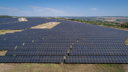 Aerial shot of photovoltaics solar farm. Solar farm power station from above. Ecological renewable energy.
