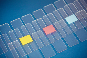 Microscopic slides with yellow red and blue lable color on the blue background