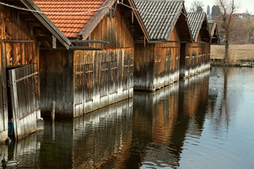 Number of wooden boat houses standing in water