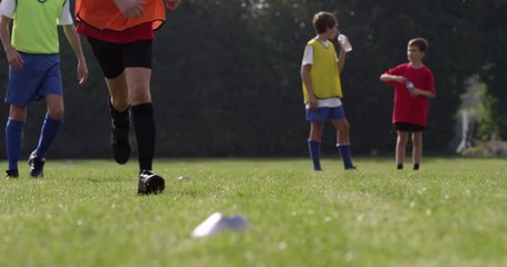 Group of boys training before their soccer match.Shot in slow motion on RED Epic