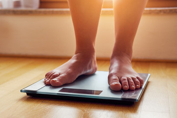 Female bare feet on weight scale
