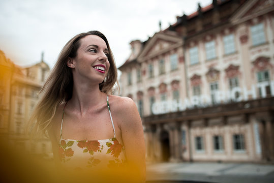 Woman sitting in a flower dress at old town square in prague, czech replic